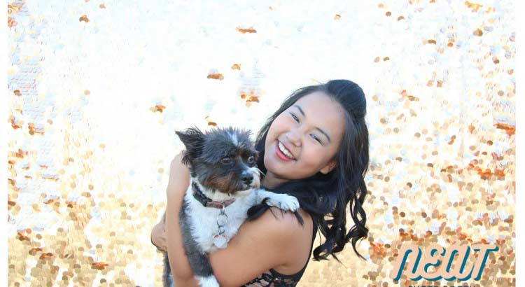 A girl and her dog using a photobooth for a grade 9 graduation.